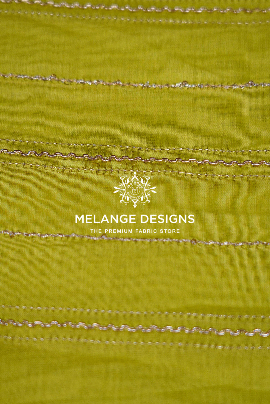 A close-up of a lime green Chanderi Silk Embroidery Fabric with horizontal metallic gold zigzag stitched lines .