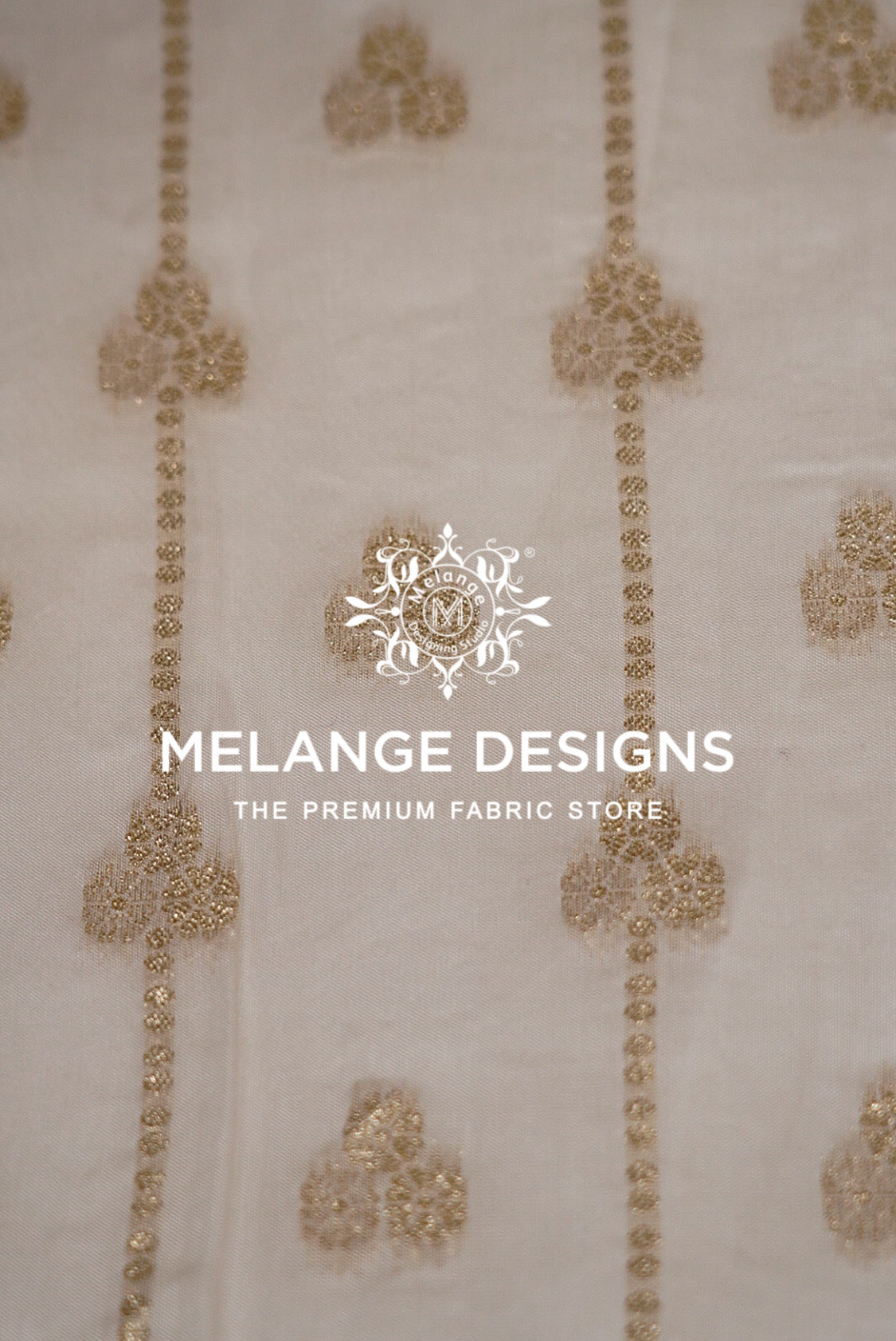 Close-up of a light beige Viscose Jaqured Dyeable Fabric with vertical gold embroidered patterns.