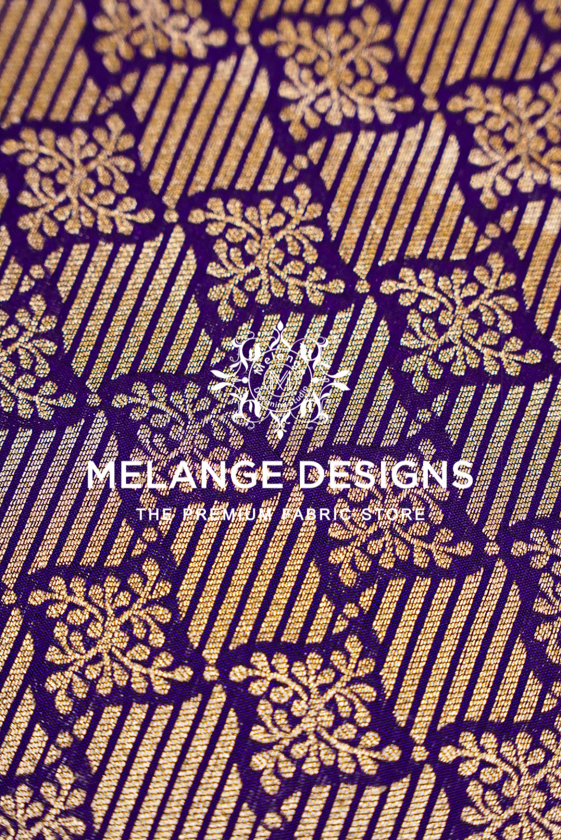 A close-up of a woven potli bags, clutches, borders and statement panels pattern featuring metallic gold floral and striped motifs on a deep purple .