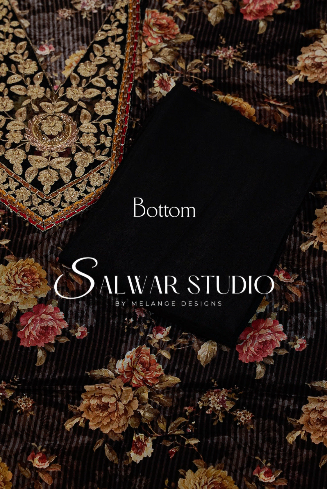 A folded black fabric piece labeled 'Bottom' lies on top of a dark floral printed textile with ornate gold embroidery .