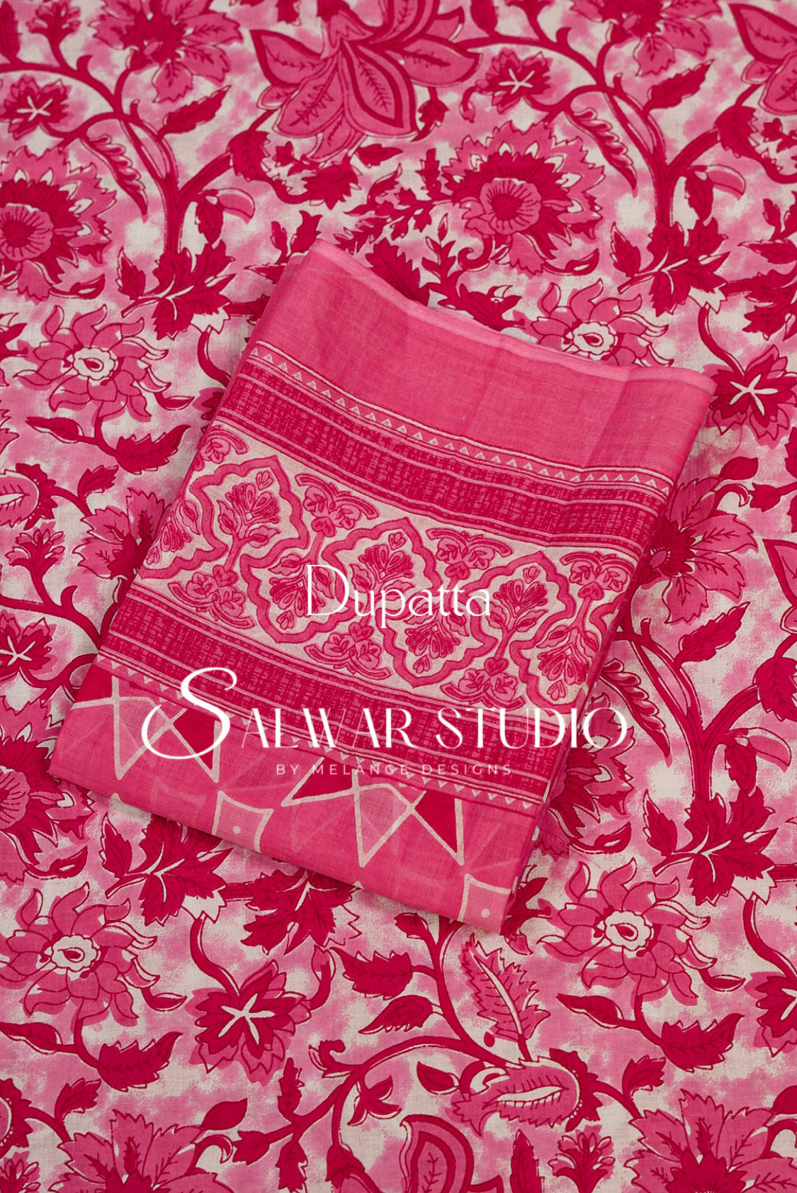 A folded pink dupatta with ornate floral and paisley patterns and border details.