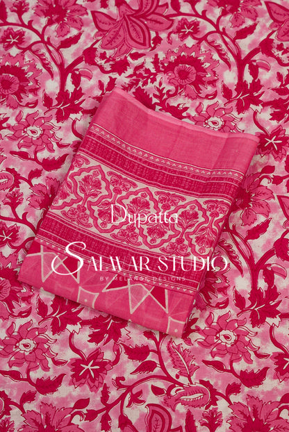 A folded pink dupatta with ornate floral and paisley patterns and border details.