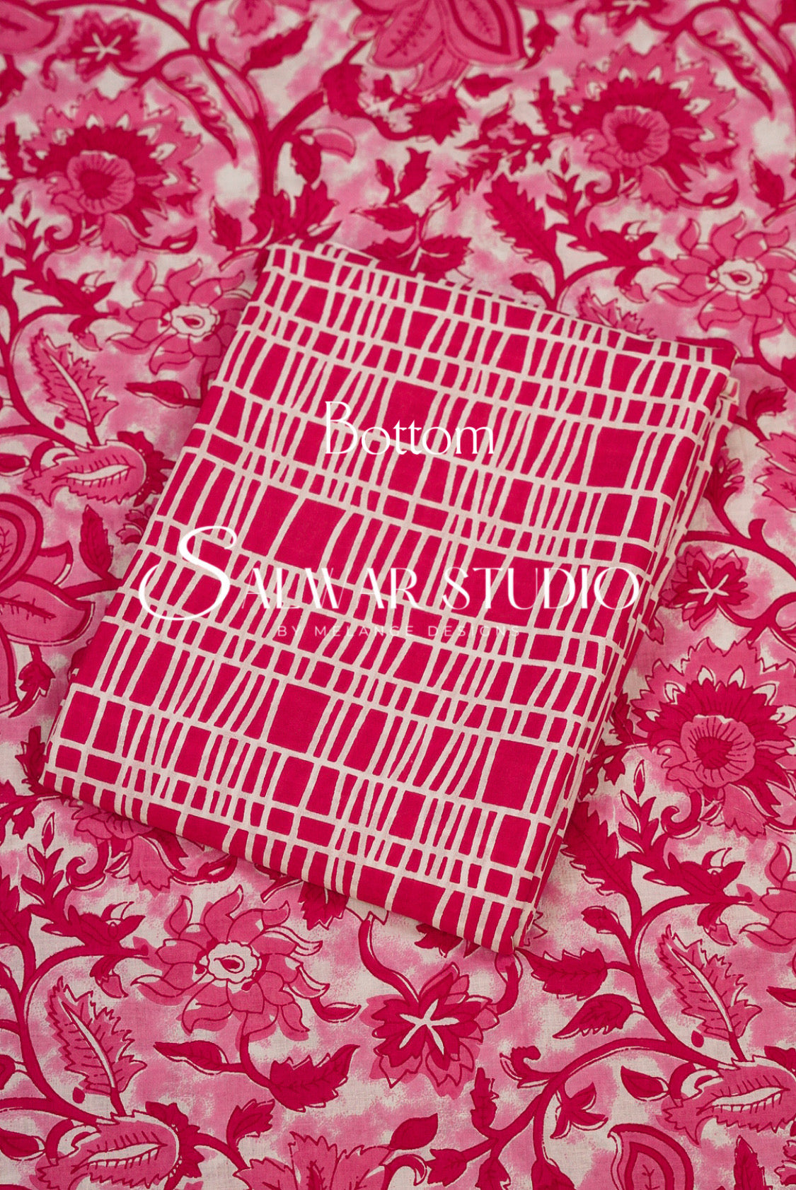 A folded fabric sample with a pink and white grid pattern.