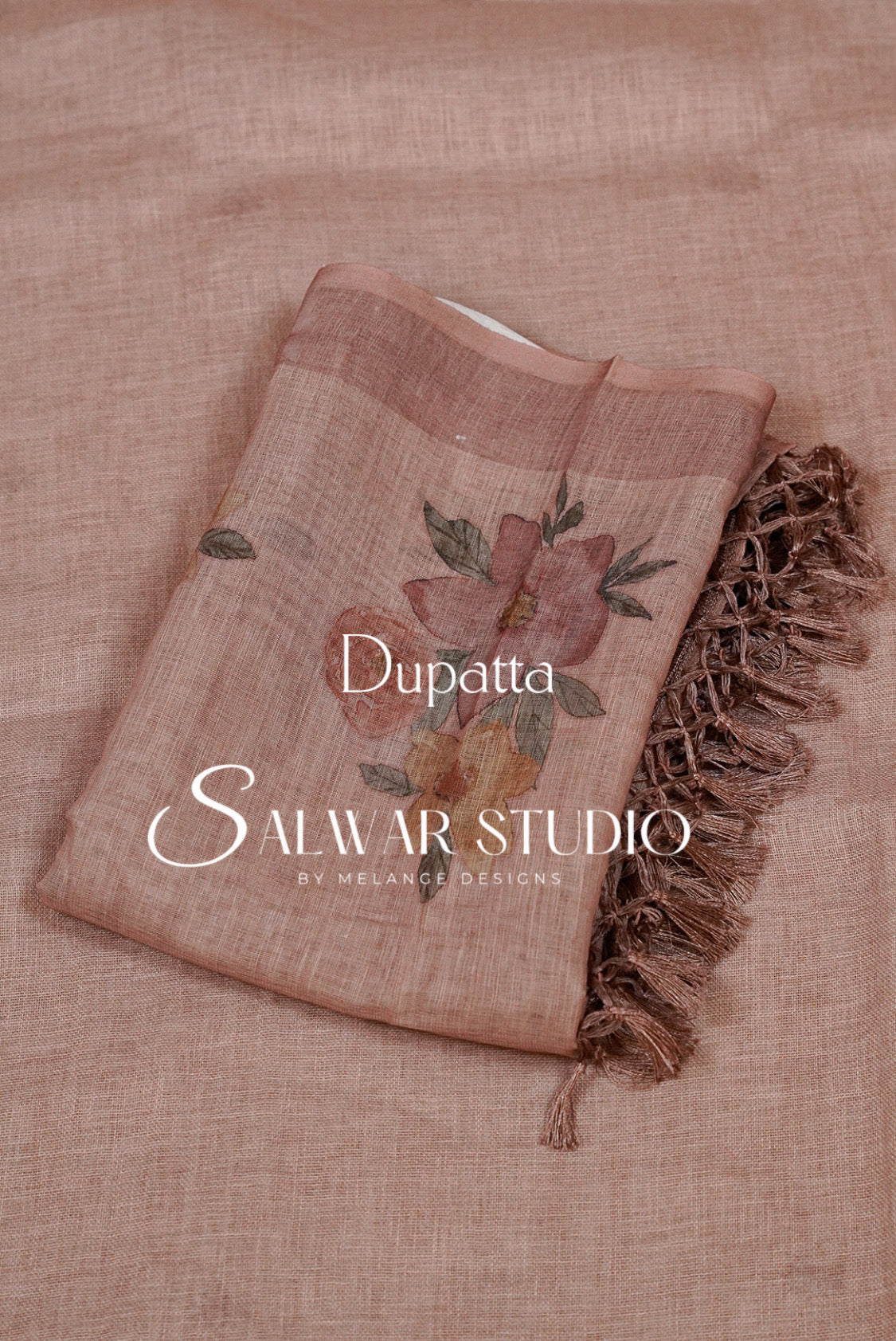 A dusty rose dupatta with a floral print and fringed edge.