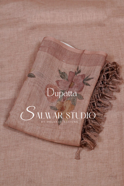 A dusty rose dupatta with a floral print and fringed edge.