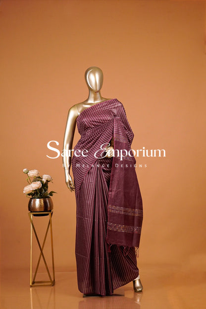 deep plum saree with vertical stripes .