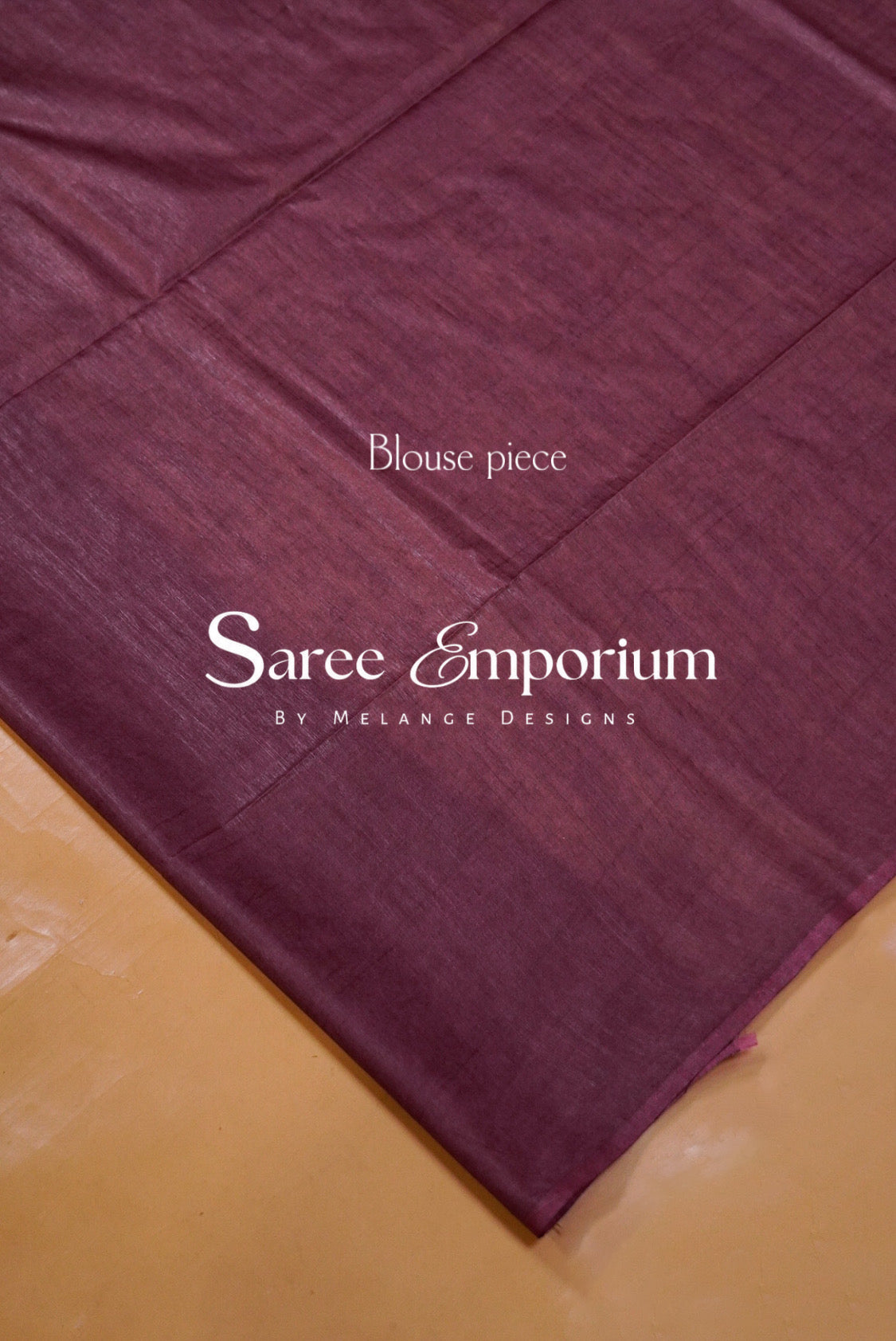 A close-up of a deep plum purple fabric.