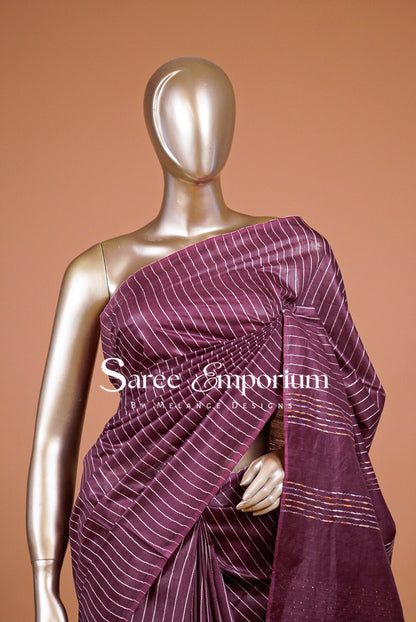  deep plum saree with fine white stripes .