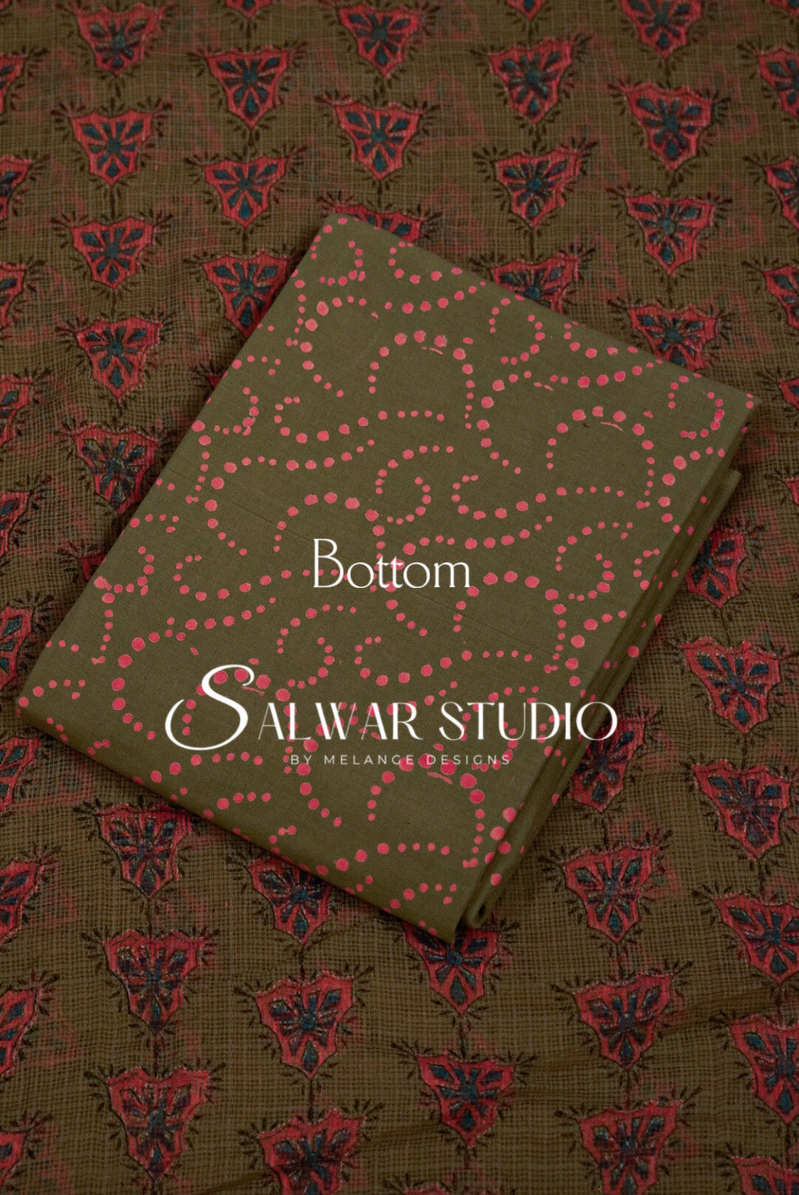 A folded fabric sample or book-like product with an olive green cover and pink dotted wavy pattern, placed diagonally on top of a matching patterned textile. 