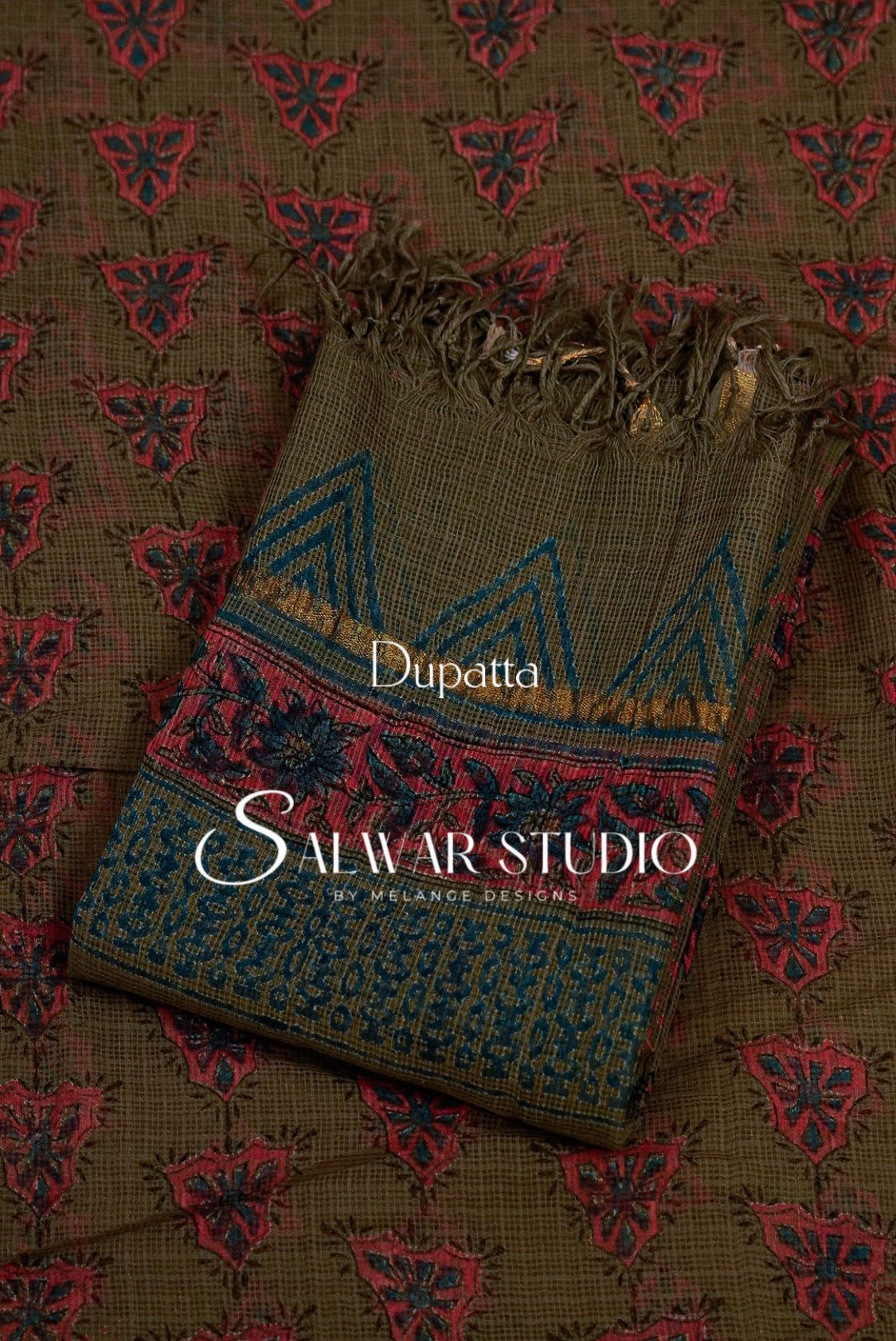 A folded dupatta with a brown base, red floral motifs, and blue geometric borders. 