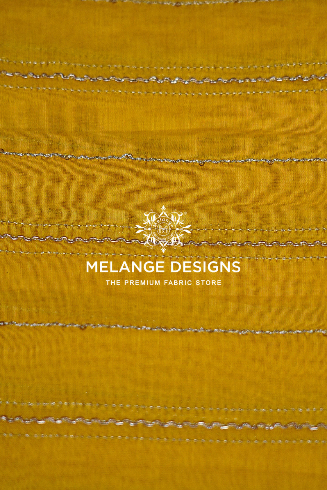 A close-up of a mustard yellow Chanderi Silk Embroidery Fabric  with horizontal metallic silver stitched stripes .