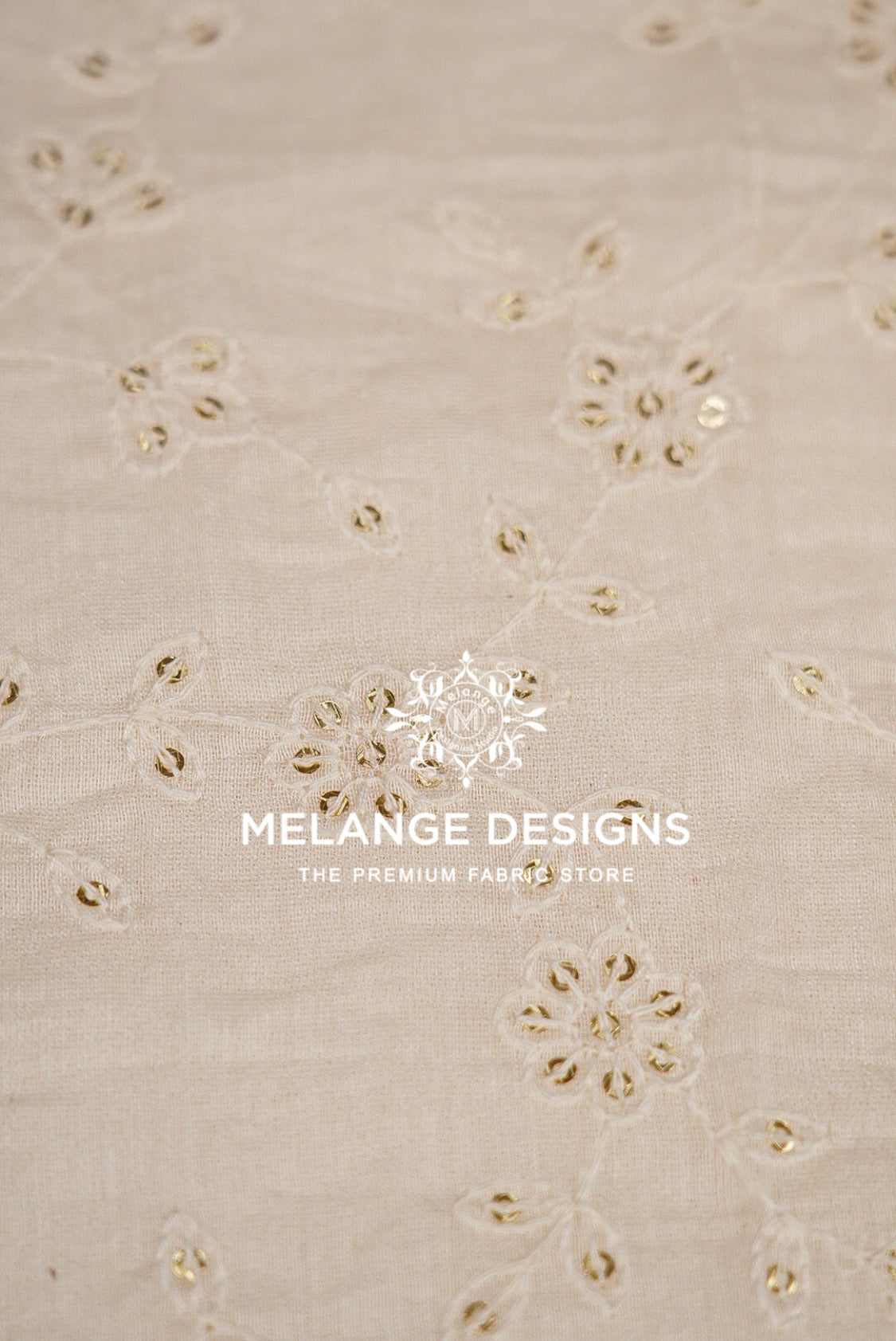 Beige cotton Chanderi Silk Embroidery Fabric with embroidered floral patterns and small metallic gold sequins.
