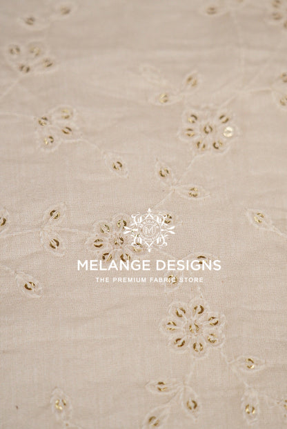 Beige cotton Chanderi Silk Embroidery Fabric with embroidered floral patterns and small metallic gold sequins.