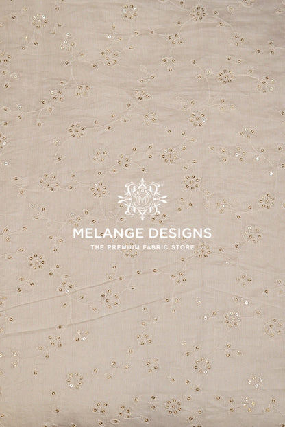 Beige cotton Chanderi Silk Embroidery Fabric with delicate floral eyelet embroidery and sequin embellishments.