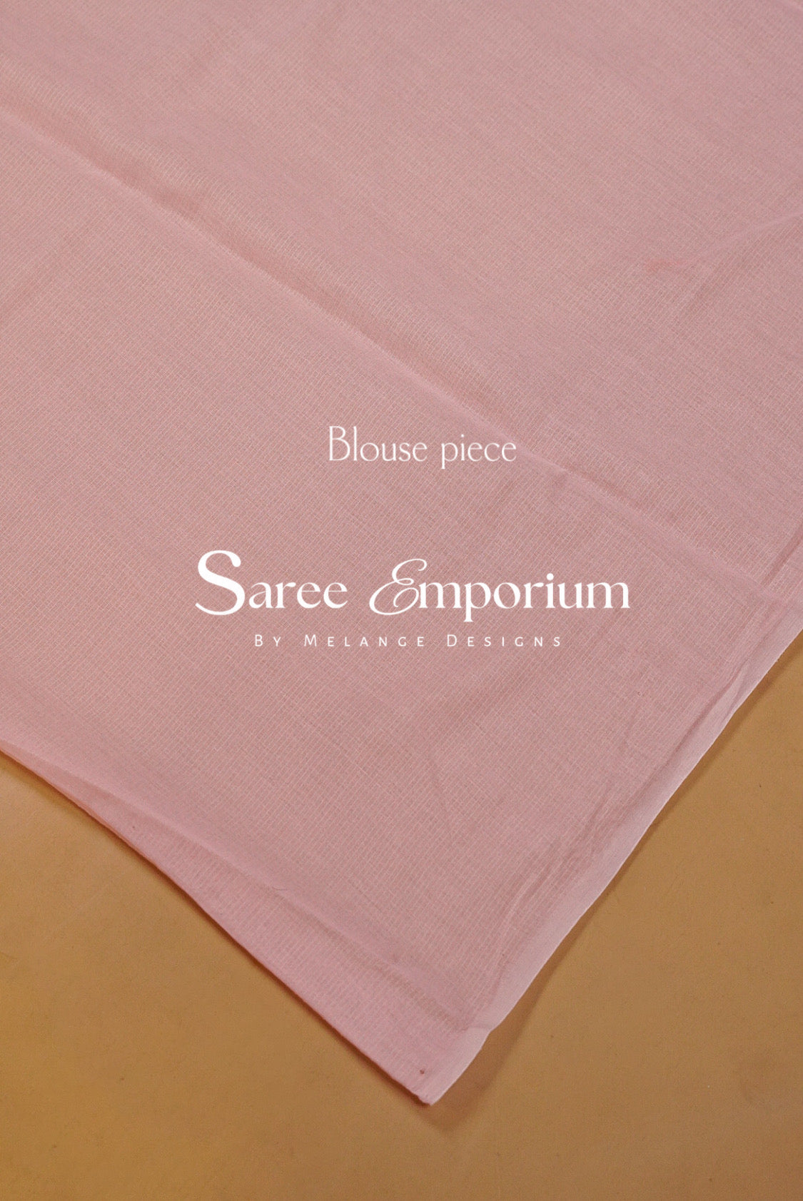 A close-up of a light pink fabric piece, likely a blouse or saree fabric.
