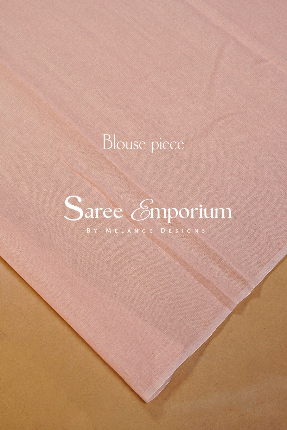 A pale blush pink sheer fabric blouse piece laid diagonally on a warm beige surface.