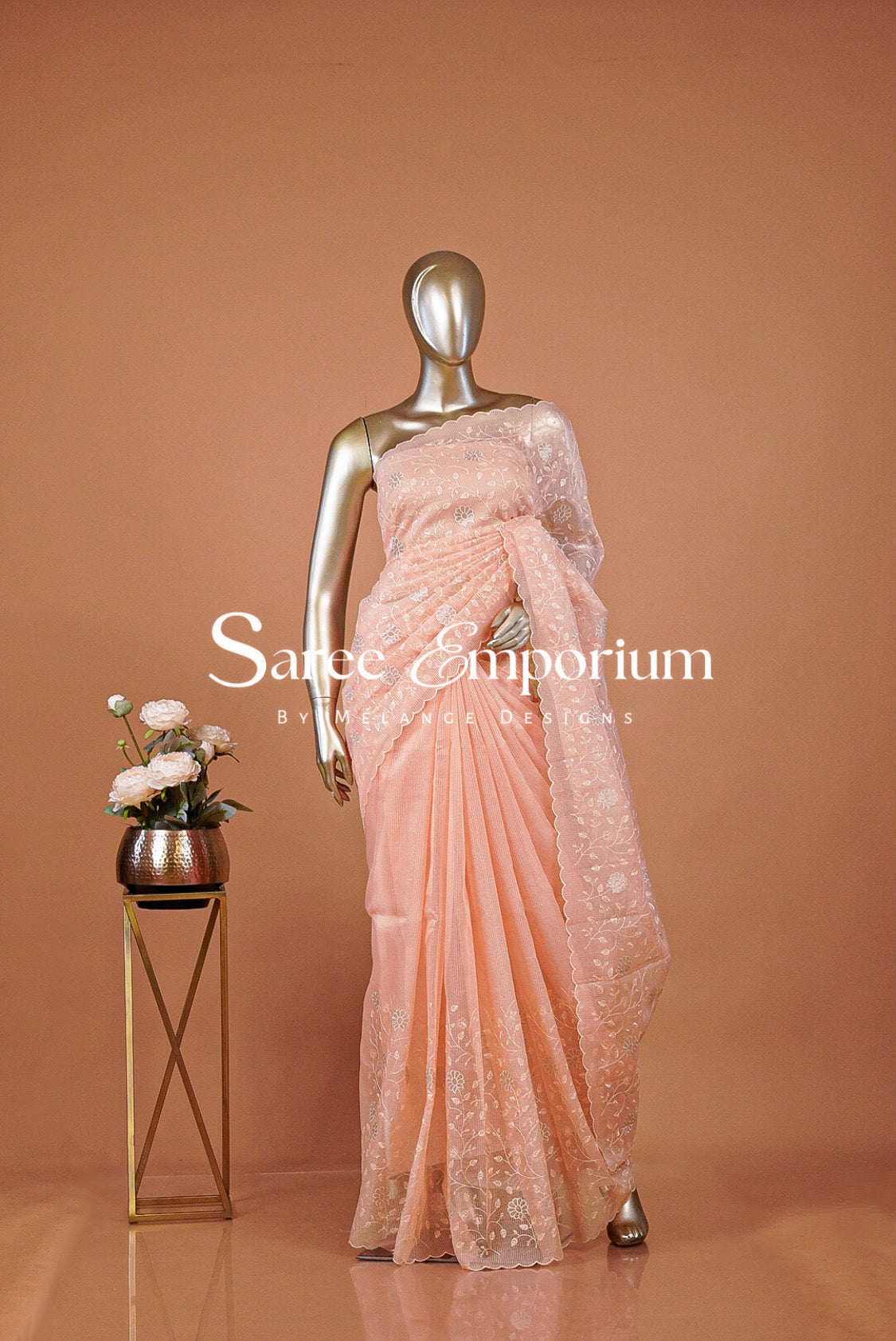 A peach-colored lace and silk saree .