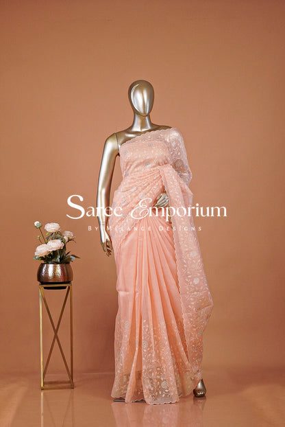 A peach-colored lace and silk saree .