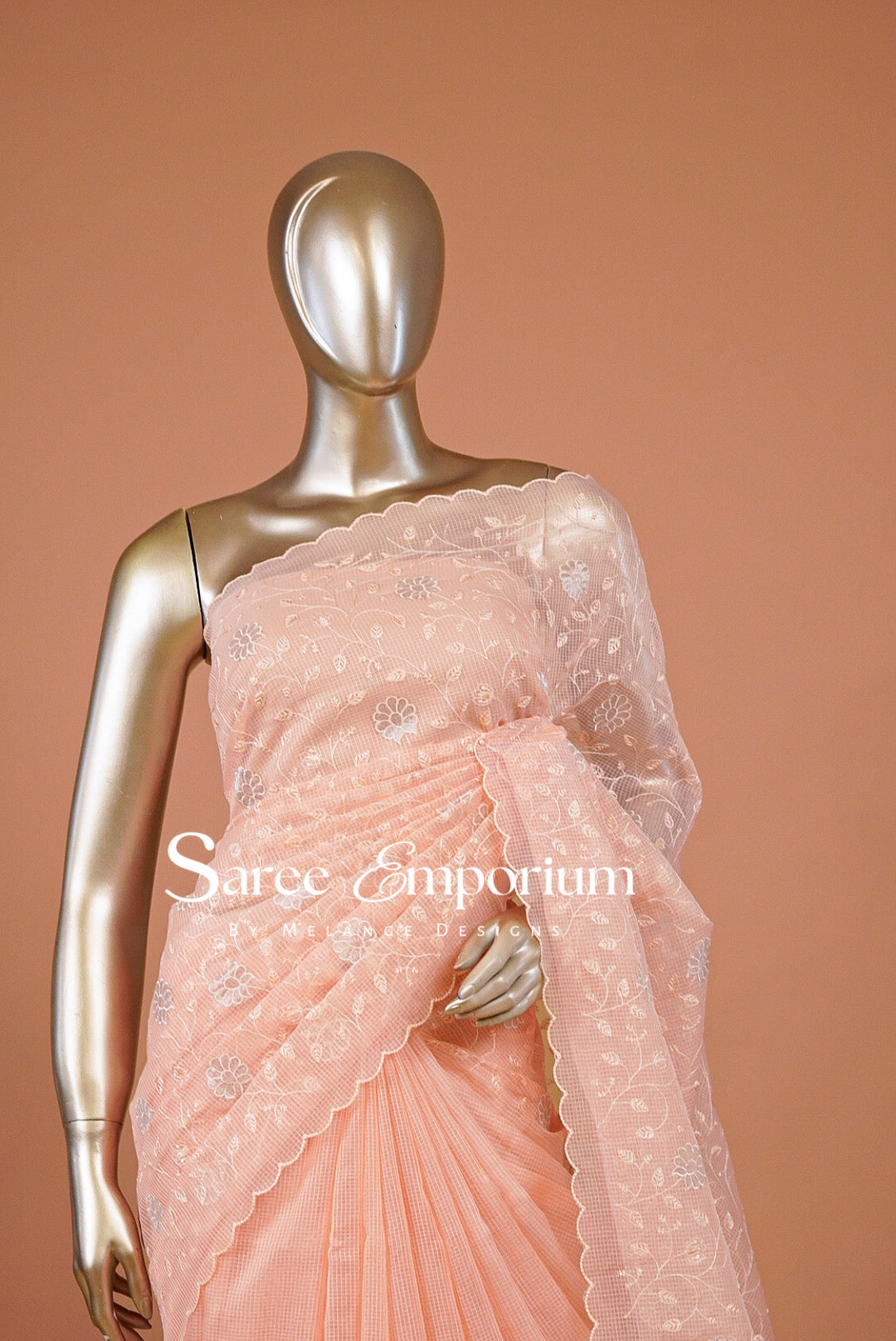 A peach-colored embroidered saree .