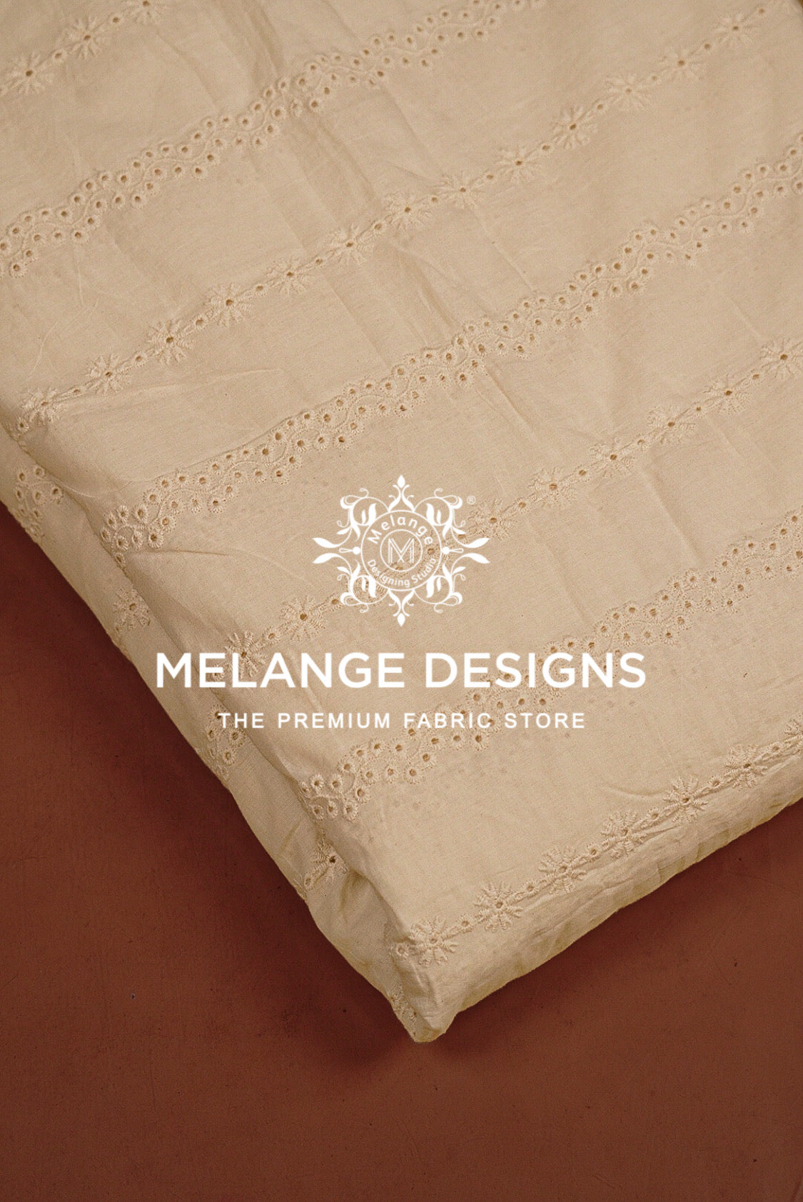 A close-up of a cream-colored Cotton Hacoba Fabric Dyeable with delicate eyelet embroidery.