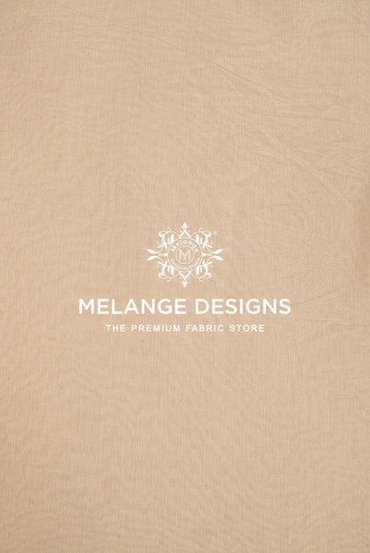 A close-up of a beige Cotton Mul Chanderi Fabric Dyeable .