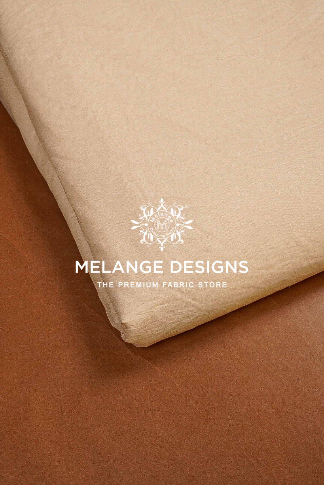 A close-up of folded beige Cotton Mul Chanderi Fabric Dyeable with a white. 