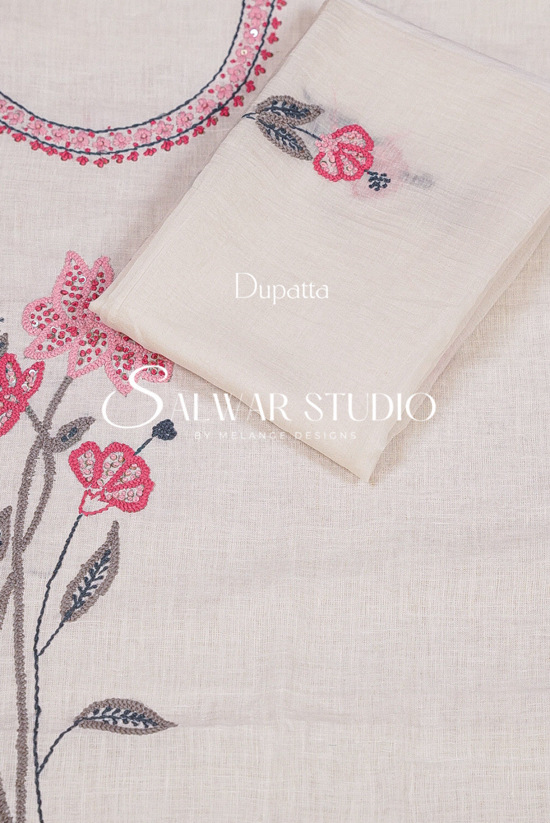 A folded cream dupatta with pink floral embroidery and gray leaf details. 