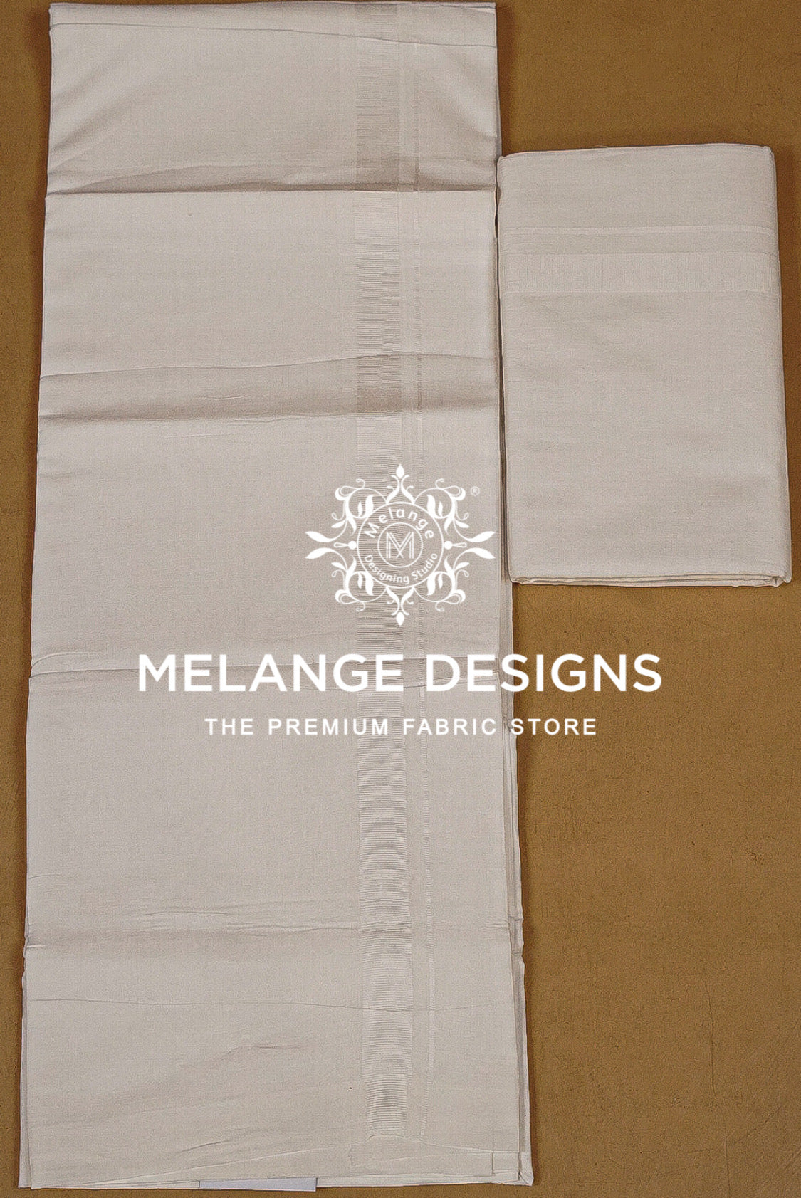 Two folded and laid-out pieces of off-white fabric .