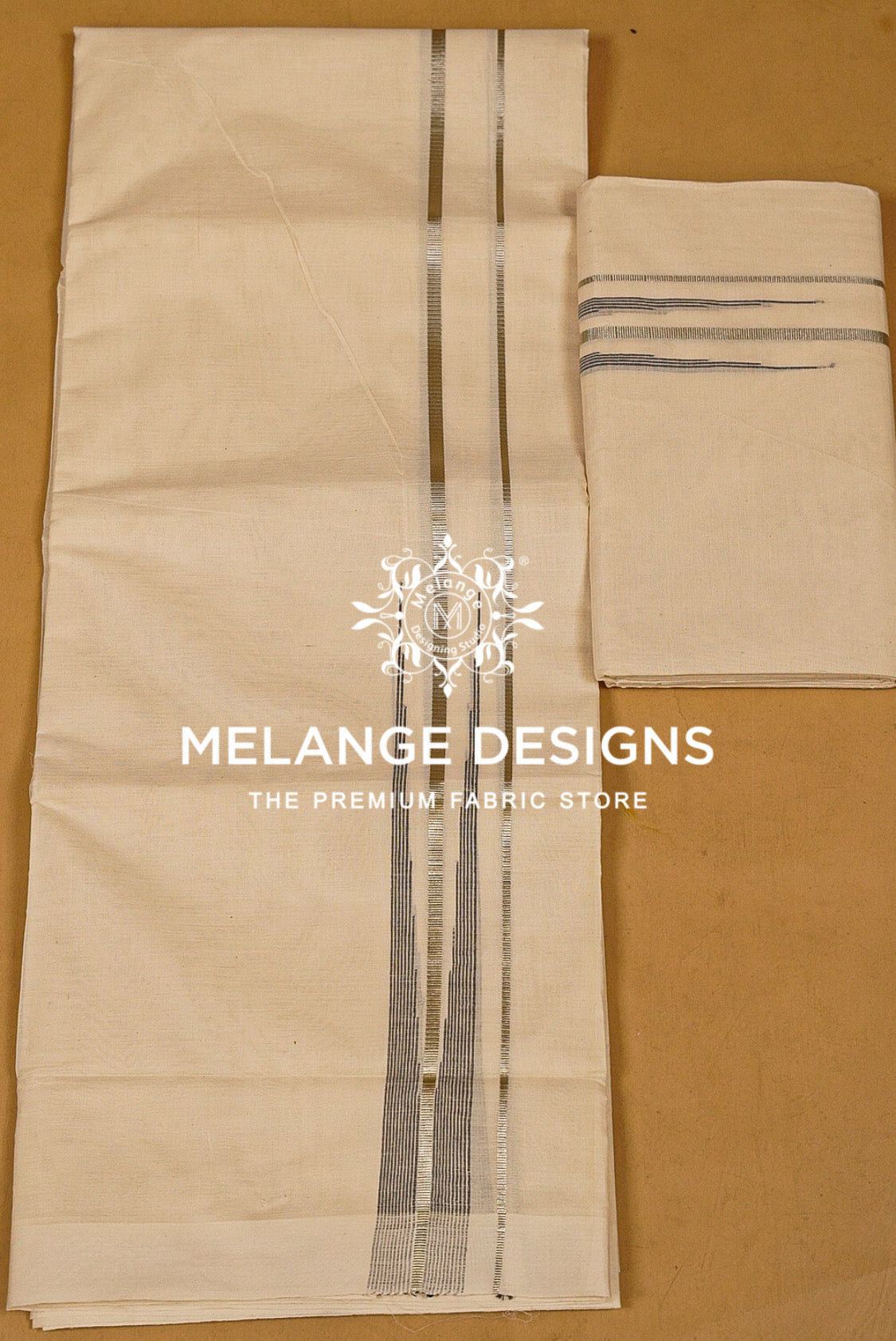A folded beige fabric piece with vertical metallic silver stripes, shown alongside a smaller matching folded .