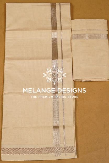 A light beige cotton dhotis featuring a central silver metallic border .