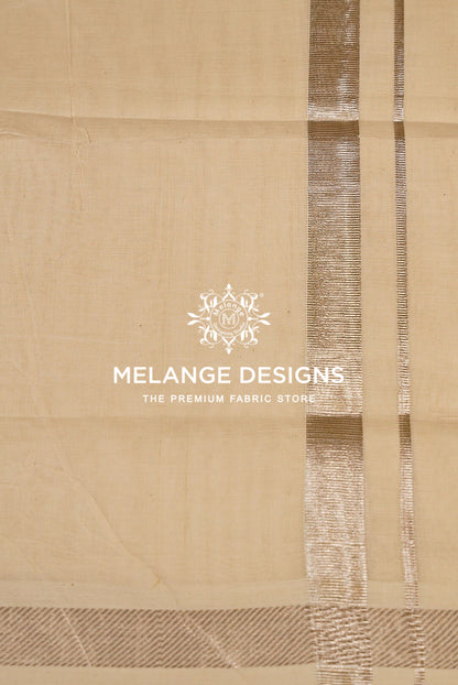 A close-up of a beige fabric with vertical metallic gold stripes and a textured border.