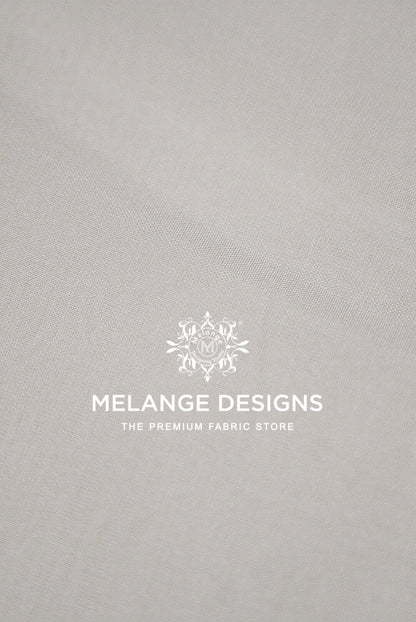 A close-up of a light gray Premium Viscose Organza Fabric Dyeable .