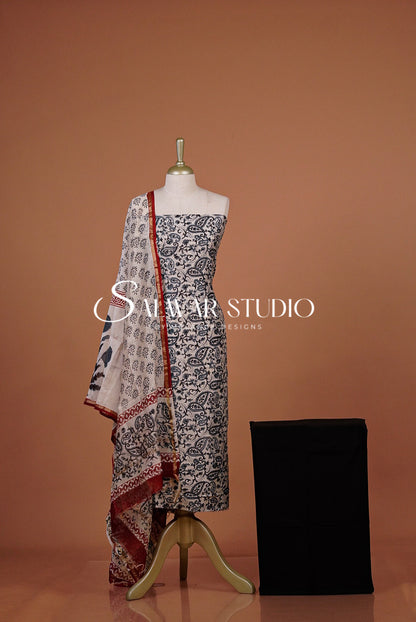 A sleeveless printed dress with a matching printed dupatta  A black fabric bottom