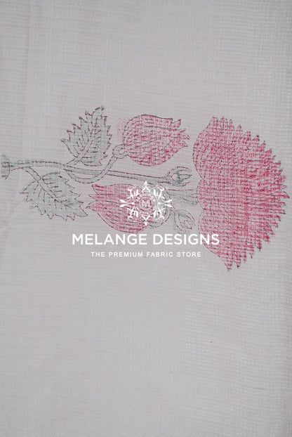 A close-up of a white textured Printed Cotton Cotta Fabric featuring a pink and gray floral block print. 