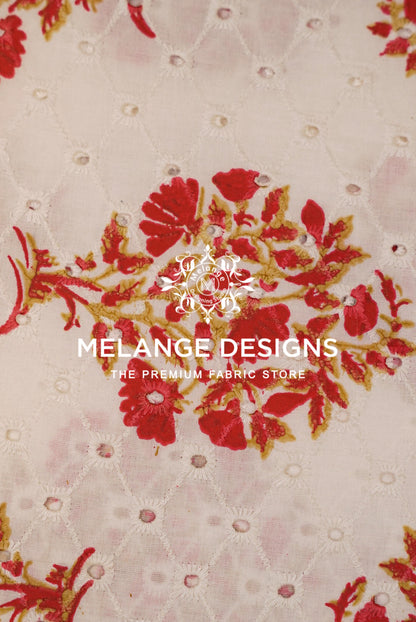 A close-up of a Printed Cotton Hacoba Fabric pattern featuring red floral motifs with gold outlines on a light beige background with a subtle diamond quilted texture. 