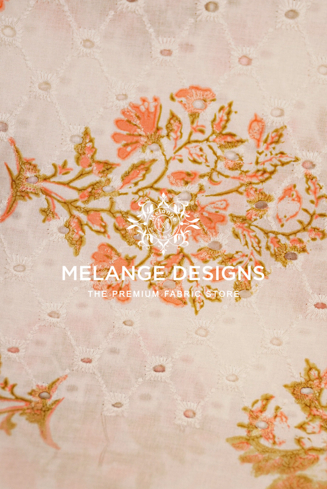 A close-up of a light beige Printed Cotton Hacoba Fabric with a subtle diamond quilted texture and embroidered floral motifs in coral pink and olive green. 