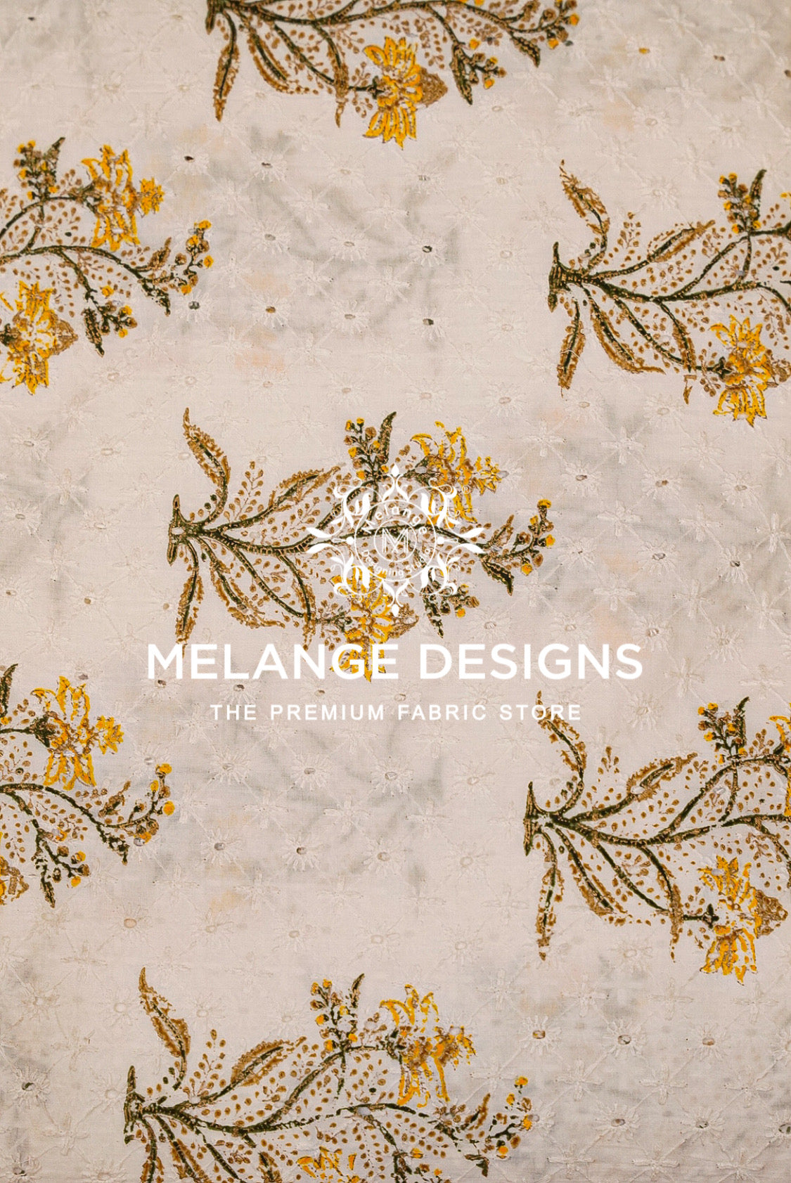 A close-up of a Printed Cotton Hacoba Fabric pattern featuring yellow and brown floral branches on a textured off-white .