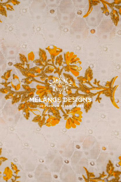 A close-up of a Printed Cotton Hacoba Fabric sample featuring a beige base with a quilted diamond pattern and a central gold floral embroidery motif. 
