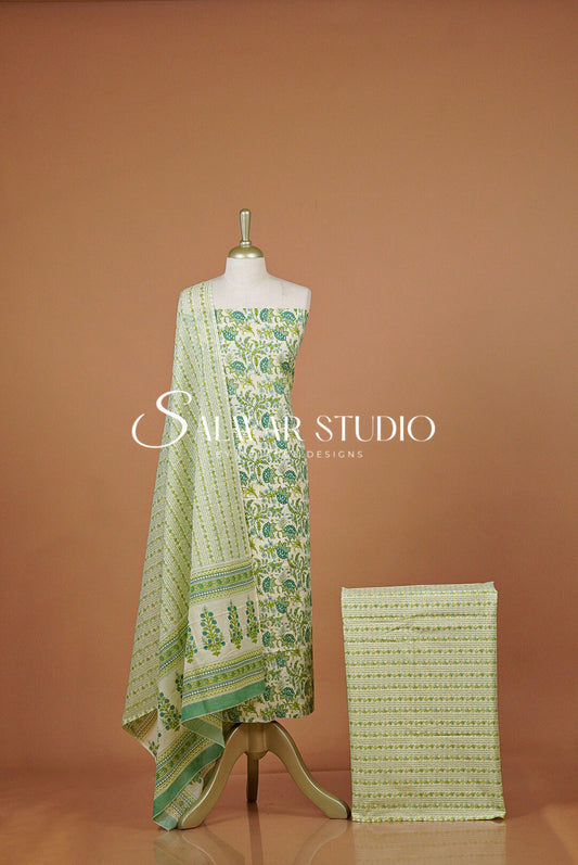 A light green and white printed salwar suit set  featuring a printed kurta, draped dupatta.