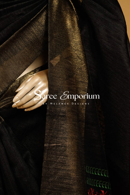 A close-up of a black and metallic gold sari draped elegantly.