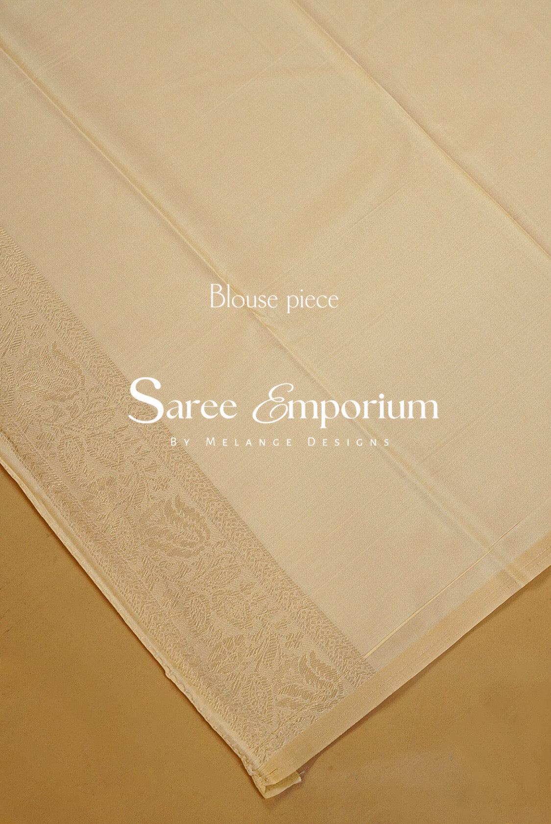A cream-colored cotton sari fabric with a detailed floral border.