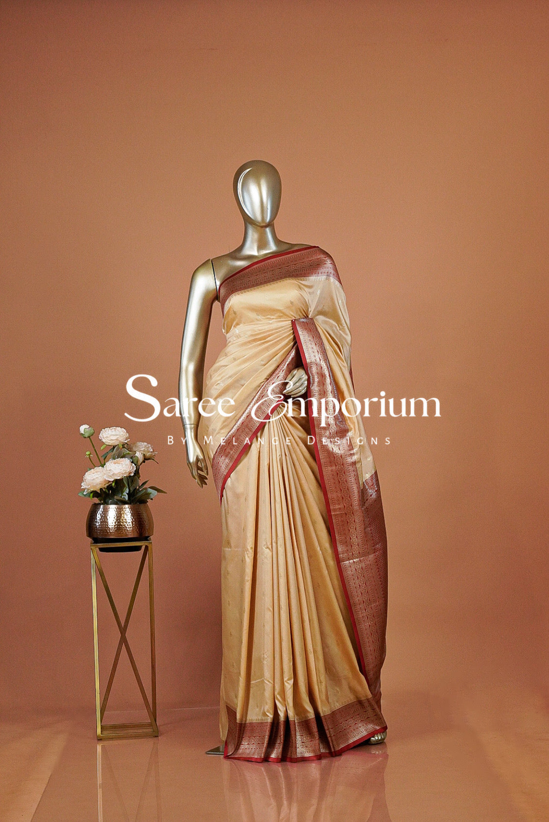 A gold-colored silk saree with a deep red border .