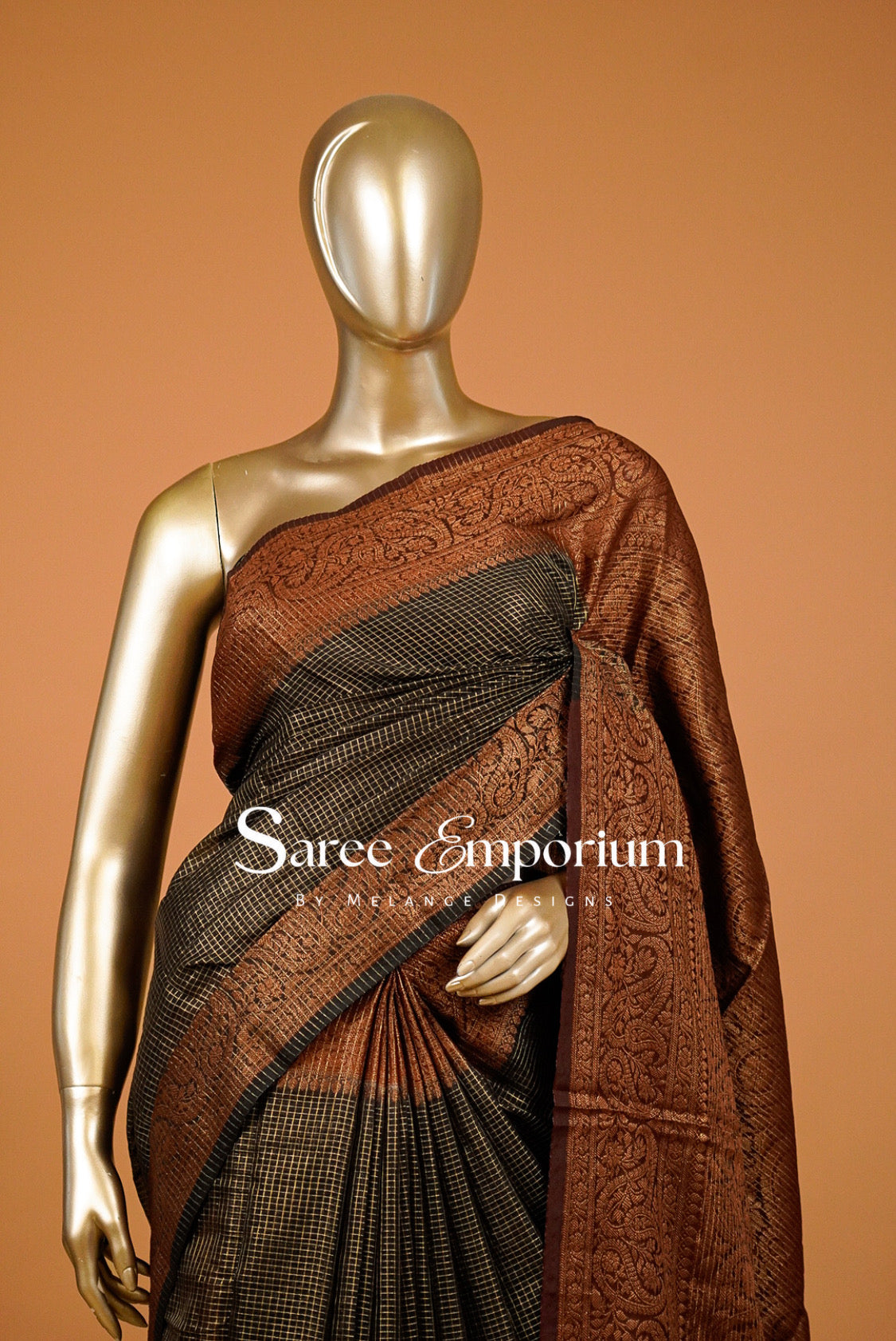rust and black saree with intricate woven patterns .