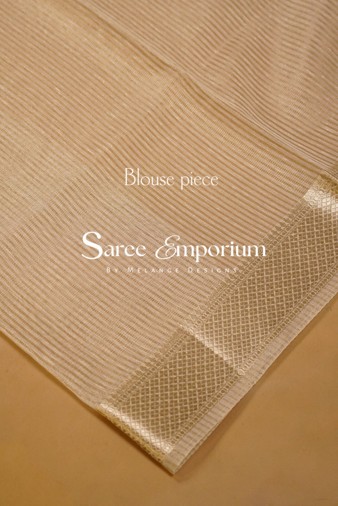 A close-up of a beige saree fabric with fine vertical stripes and a woven border.