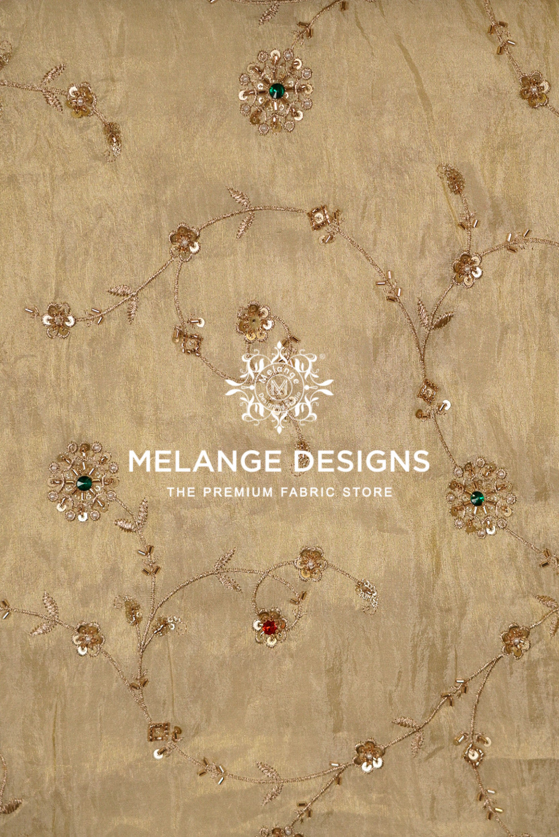 A close-up of a beige Tissue Silk Embroidery Fabric with delicate gold floral embroidery .