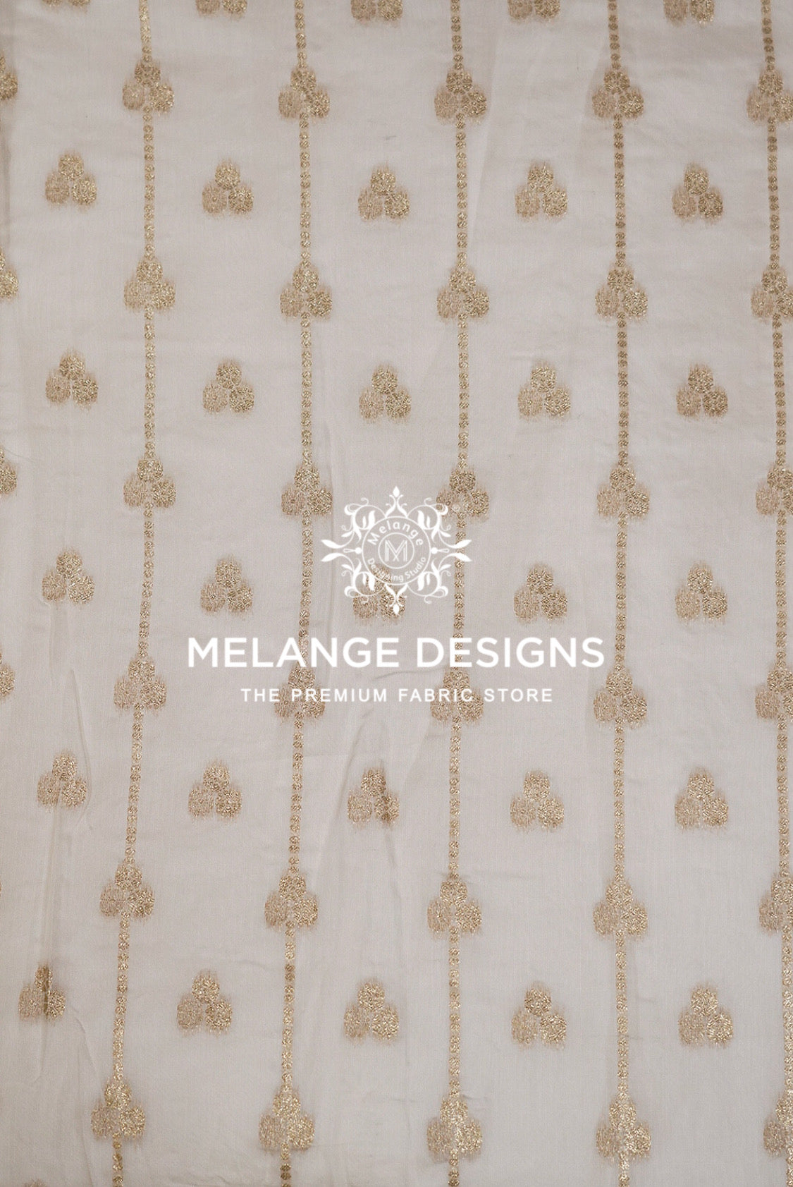 White organza Viscose Jaqured Dyeable Fabric with vertical gold sequin chains and small gold embroidered motifs.