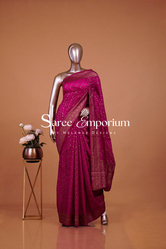  deep magenta-fuchsia saree with subtle gold motifs.