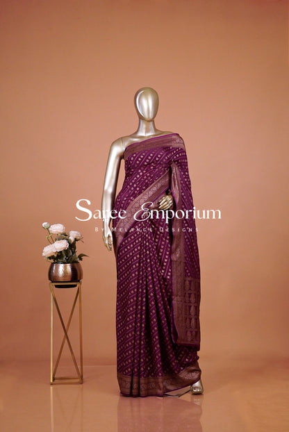 deep magenta purple saree with intricate gold motifs.