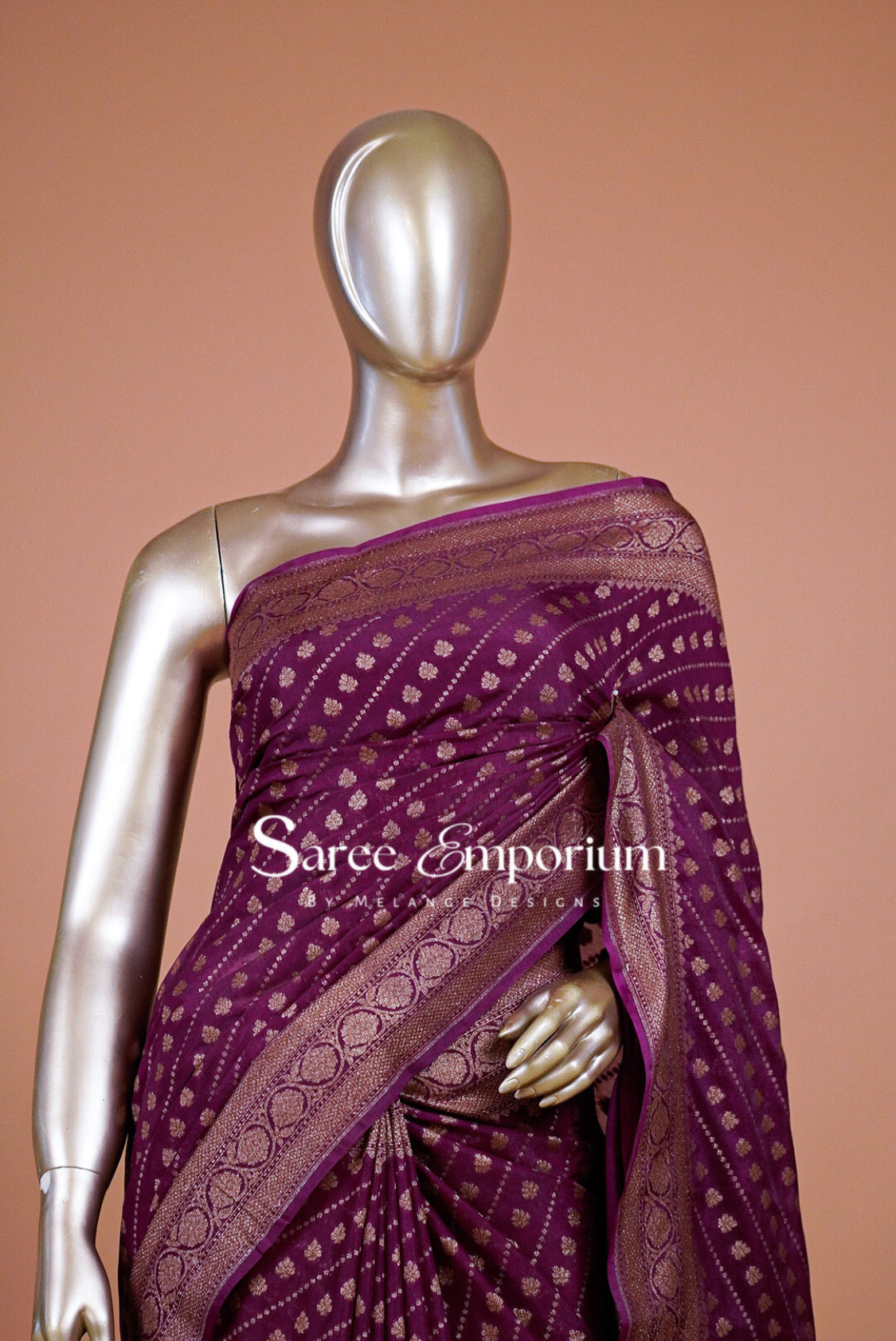  deep purple saree with intricate gold zari patterns and borders.