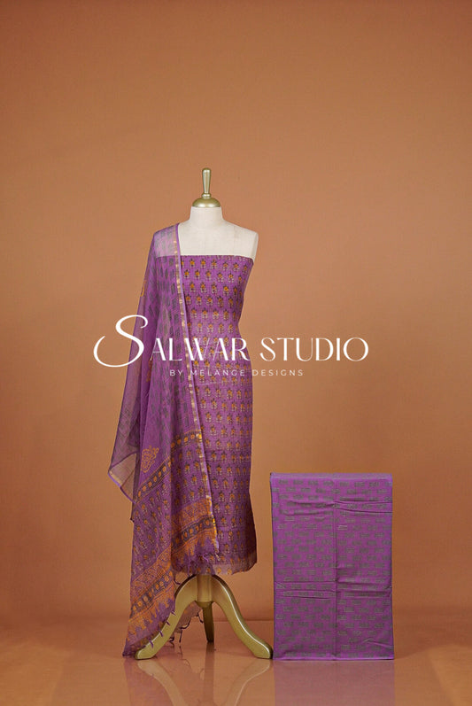 A purple salwar suit set. The set includes a printed purple kurta  a matching dupatta.